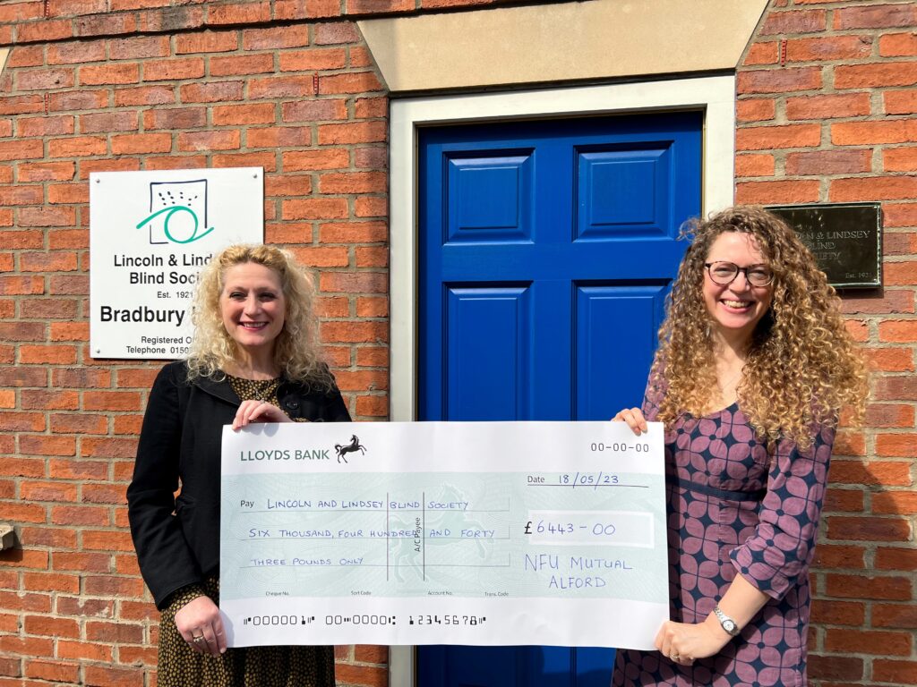Pictured is Susie Smith, NFU Mutual Agent for Alford presenting the cheque to Ingrid Ashton, Publicity Coordinator at Lincoln and Lindsey Blind Society outside their offices on Ramsgate in Louth.